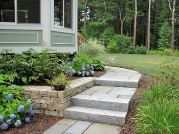 Stone walkway, retaining wall and landscaped garden